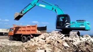 Excavator Kobelco Loading Rocks to Dump Truck Fuso