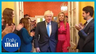 Boris Johnson and Carrie walk through Downing Street for one final time