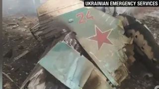 Man jumps on top of moving armored Russian vehicle while waving Ukrainian flag
