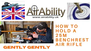 55. Holding your 25m Benchrest Air Rifle.