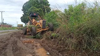 Motor Grader Performs Roadside Cleaning for Road Widening Preparation