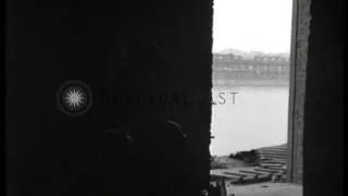 Patrol of U.S. 71st Infantry Division advances cautiously through ruins of Ludwig...HD Stock Footage