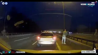 Man stops and gets out of his car on the right-lane on a freeway to pee.