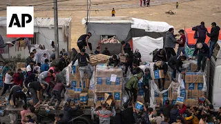 People chase after aid trucks in Gaza Strip