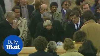 Somber family and friends attend the funeral of John Belushi