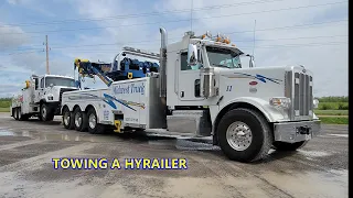 ROTATOR TOWING A LARGE HYRAILER TRUCK.