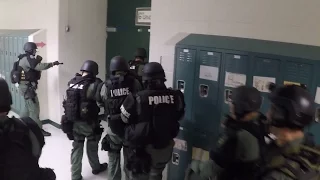 SWAT teams practice at a middle school