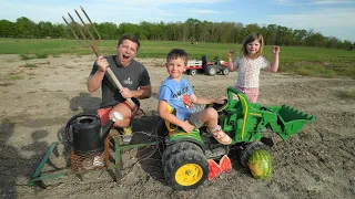 Using kids tractors to plow dirt and plant sunflowers | Tractors for kids