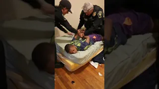 Jabari restrained by police officer