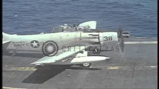 US Navy A-1H Skyraiders and a C-1A land on USS Ticonderoga in the Gulf of Tonkin. HD Stock Footage