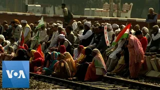 Indian Farmers Sit on Railroad Tracks in Protest