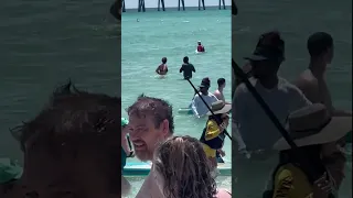 Shark gets close to swimmers at Navarre Beach in Florida