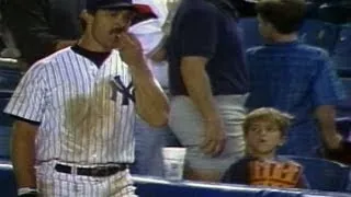 Don Mattingly helps himself to a young fan's popcorn