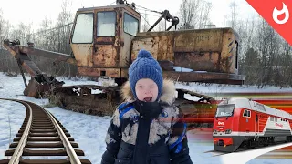 Trains and railway abandoned in winter / railway crossing and abandoned excavator