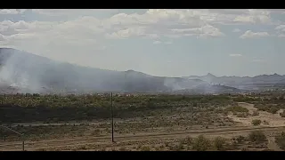 Firefighters battle a brush fire off Interstate 17