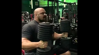 Brian Shaw presses 160 lb dumbbells for ten reps.