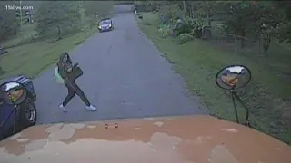 Video shows girl's frightening brush with truck running school bus stop sign