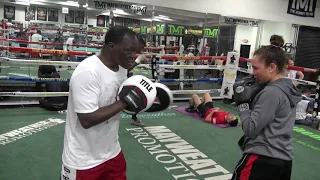 Young lady boxer working with Jeff Mayweather inside the Mayweather Boxing Club