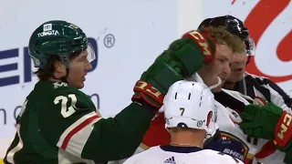 Wild and Panthers scrum Duhaime gloves Tkachuk in the face