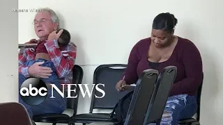 Grandfather cradles stranger's baby in waiting room