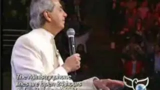 Benny Hinn sings "There's Something About That Name"