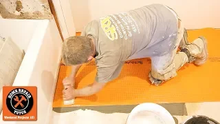 Schluter®-DITRA Tips Over Wood and Concrete in a Bathroom