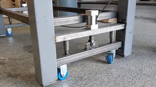 Heavy duty work bench/table with retractable wheels.