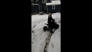 Kid mini atv drifting  in snow