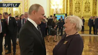 Russian President Vladimir Putin meets his first teacher