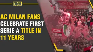 AC Milan fans celebrate after their side won a first Serie A title in 11 years