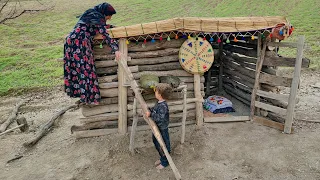 Building a hut in the mountain by a village woman and her young son