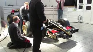 Changing a Tyre on a Lotus F1 Team Formula 1 Racing Car