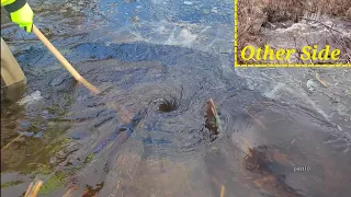 Unclogging Culverts Under Frozen Pond To Drain Flooded Road With Huge Powerful Whirlpools.