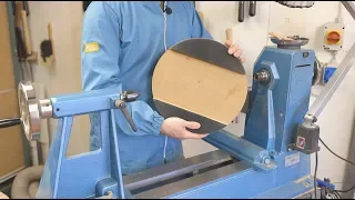 Remounting a roughed shaped salad bowl on the lathe.