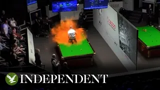 Just Stop Oil protester covers snooker table in orange powder during World Championships