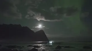 Surfing champion rides waves under the Northern Lights