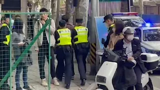 Police detain person in downtown Shanghai on Monday | AFP