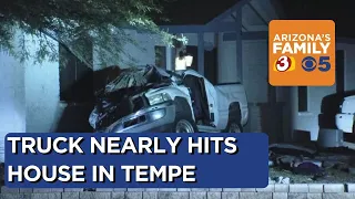 Pickup truck nearly crashes into Tempe home