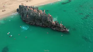 Jumping off a huge rock into Waimea Bay, Hawaii