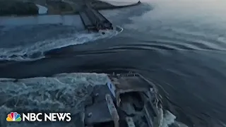 Drone video shows water surging through a huge hole in Ukraine's Kakhovka dam