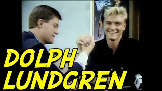 Dolph Lundgren arm wrestles a local reporter, 1988