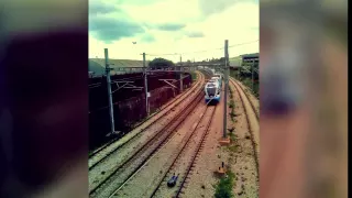 A guy lies on a railroad while train speeding