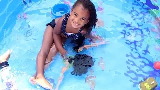 LITTLE GIRL TAKES BARBIE DOLLS SWIMMING IN THE POOL