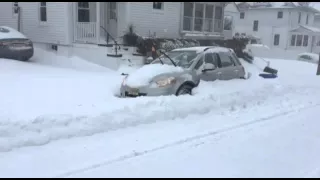 Suzuki sx4 digging it self out of snow.