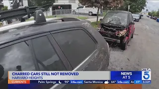 Charred cars in Harvard Heights still not removed