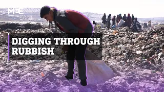 Syrian children dig through rubbish for food