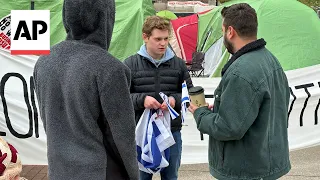 Israel supporter stands near pro-Palestinian encampment at University of Michigan