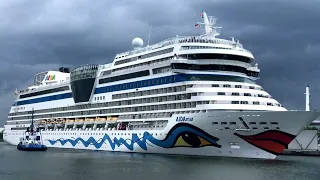 Ship ahoy! Blue ship and white ship meet. Cruise ships in the harbor.