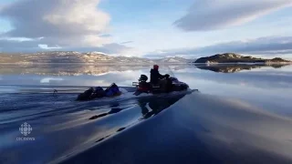 Yukon campers snowmobile across melting Lake Laberge