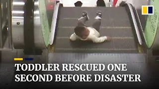 Toddler rescued from escalator one second before disaster